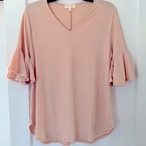 This is a brand new light pink top NEVER WORN from a boutique, size L.